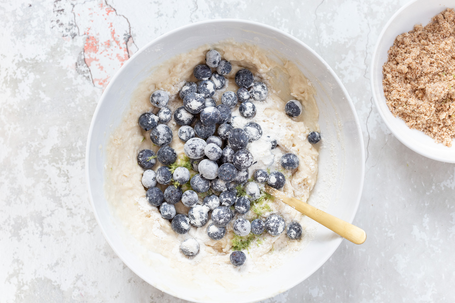 Batter for our Vegan Blueberry Muffins in a white bowl