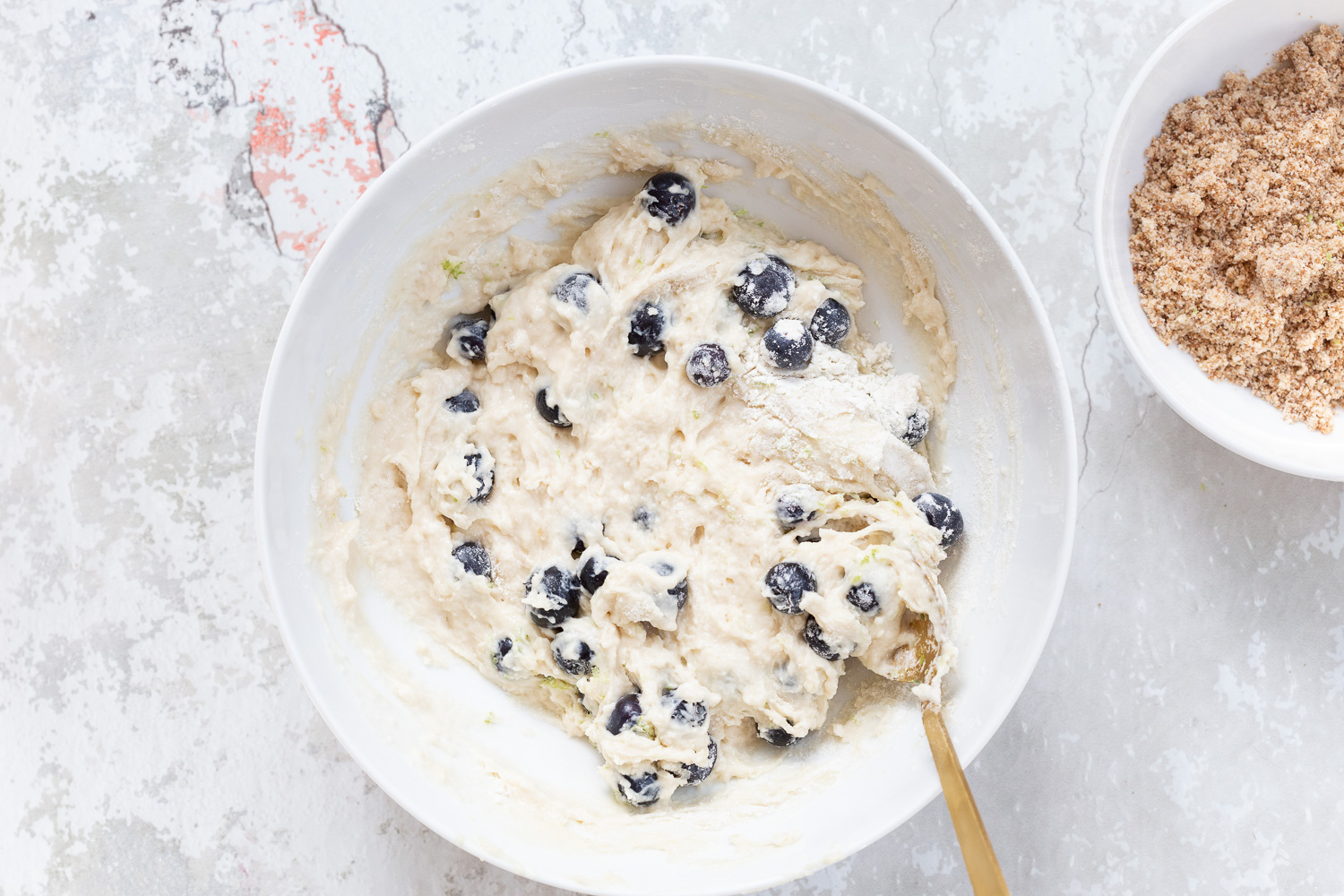 Batter for our Vegan Blueberry Muffins in a white bowl