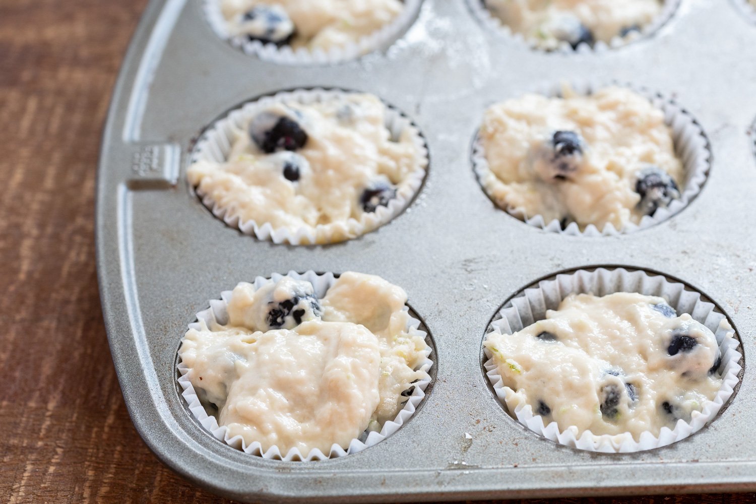 Batter for our Vegan Blueberry Muffins in muffin pan