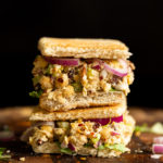 Our Chickpea Tahini Saladi n a Sandwich on wood board