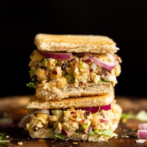 Our Chickpea Tahini Saladi n a Sandwich on wood board