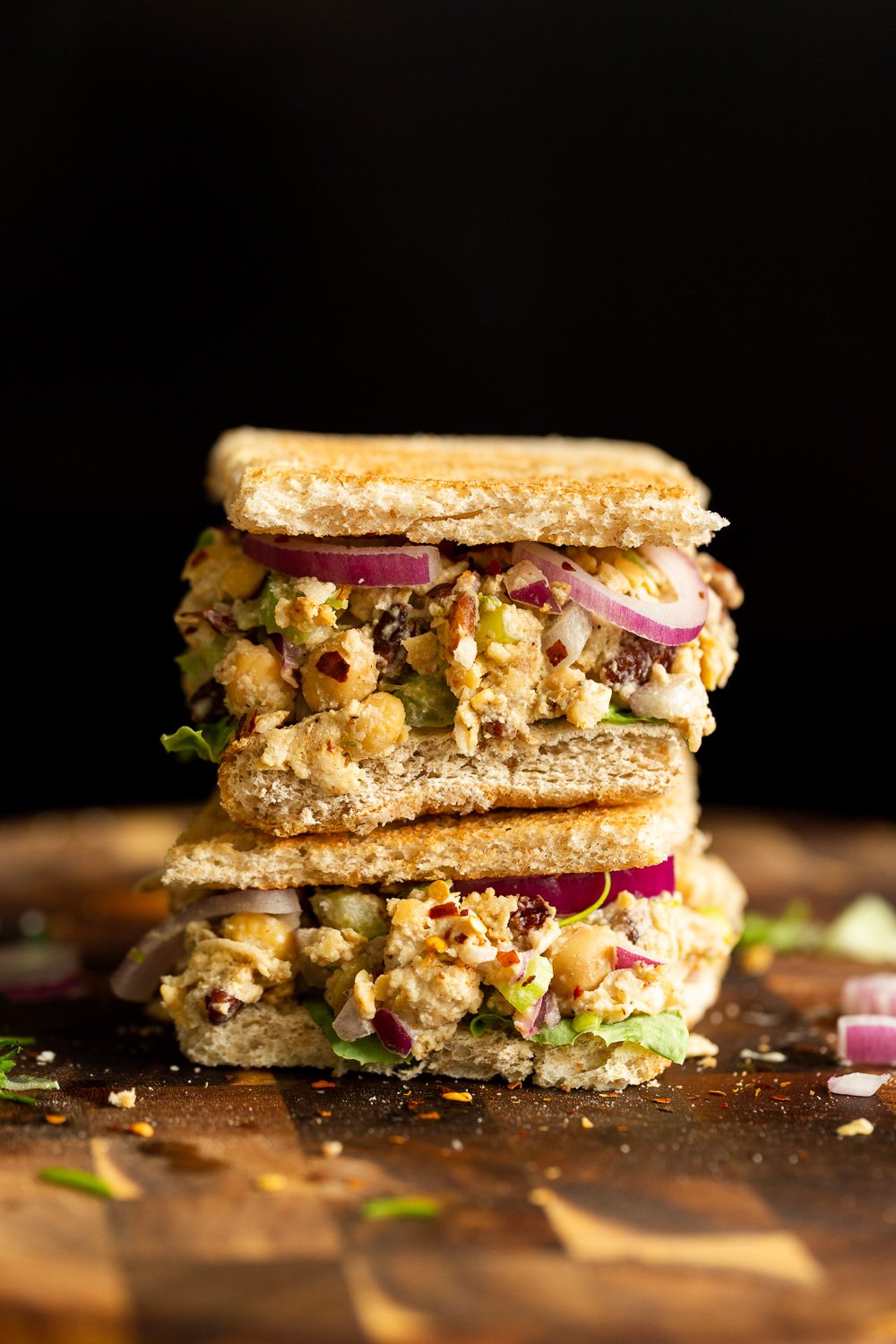 Our Chickpea Tahini Saladi n a Sandwich on wood board