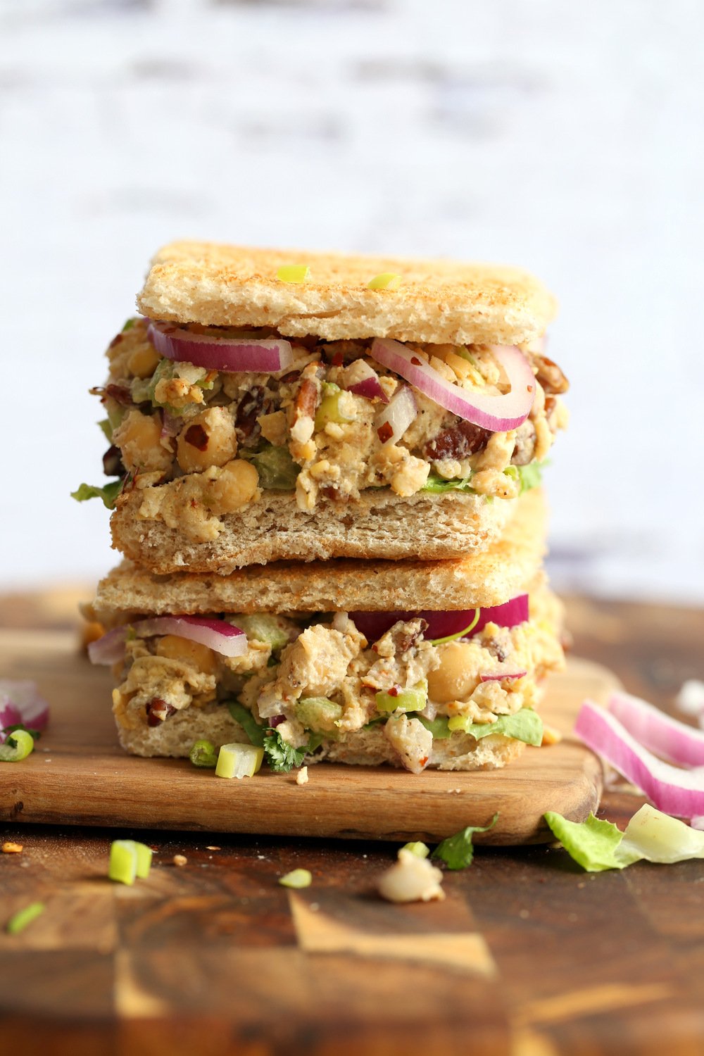 Our Chickpea Tahini Saladi n a Sandwich on wood board