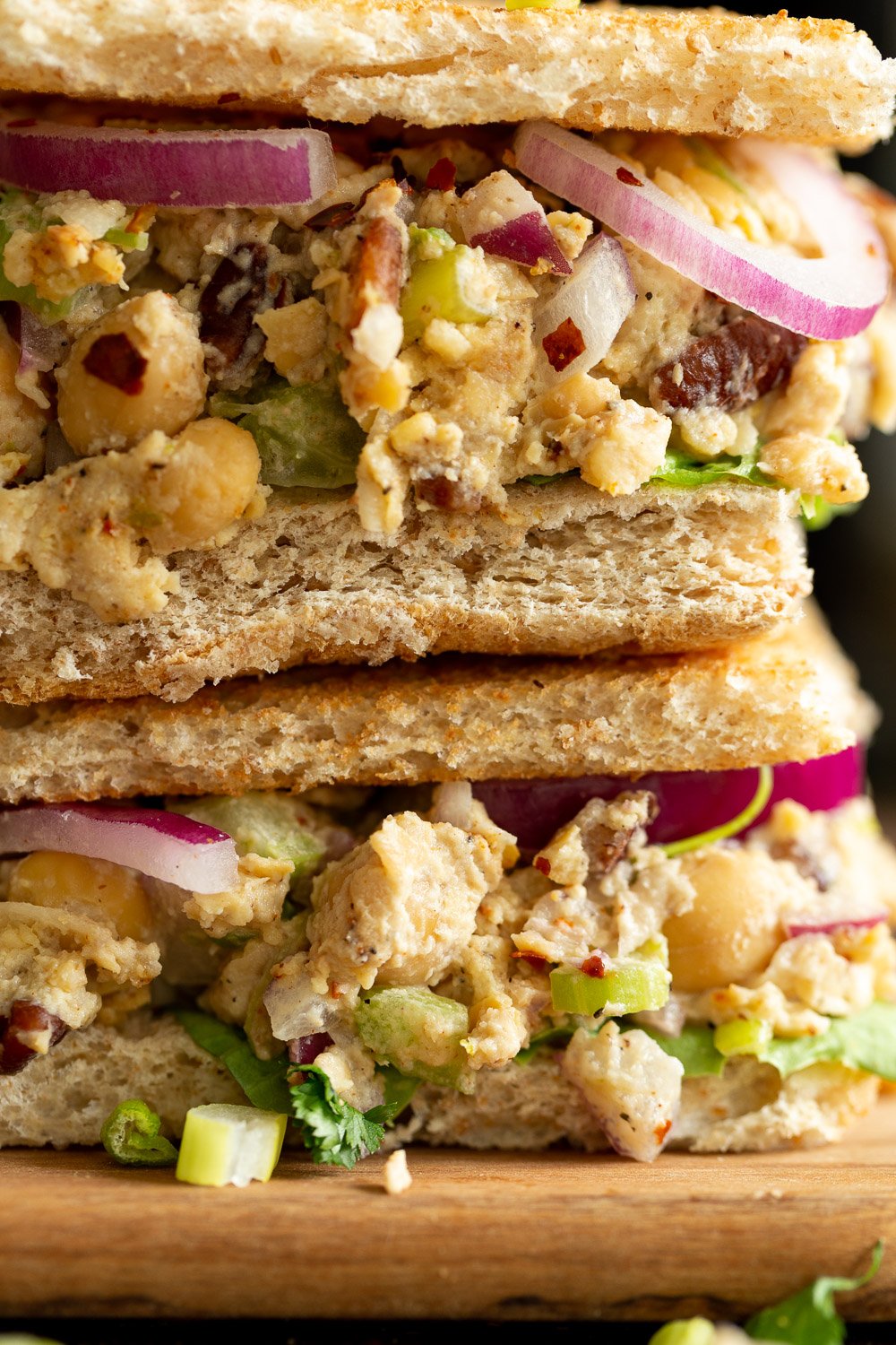 Our Chickpea Tahini Saladi n a Sandwich on wood board
