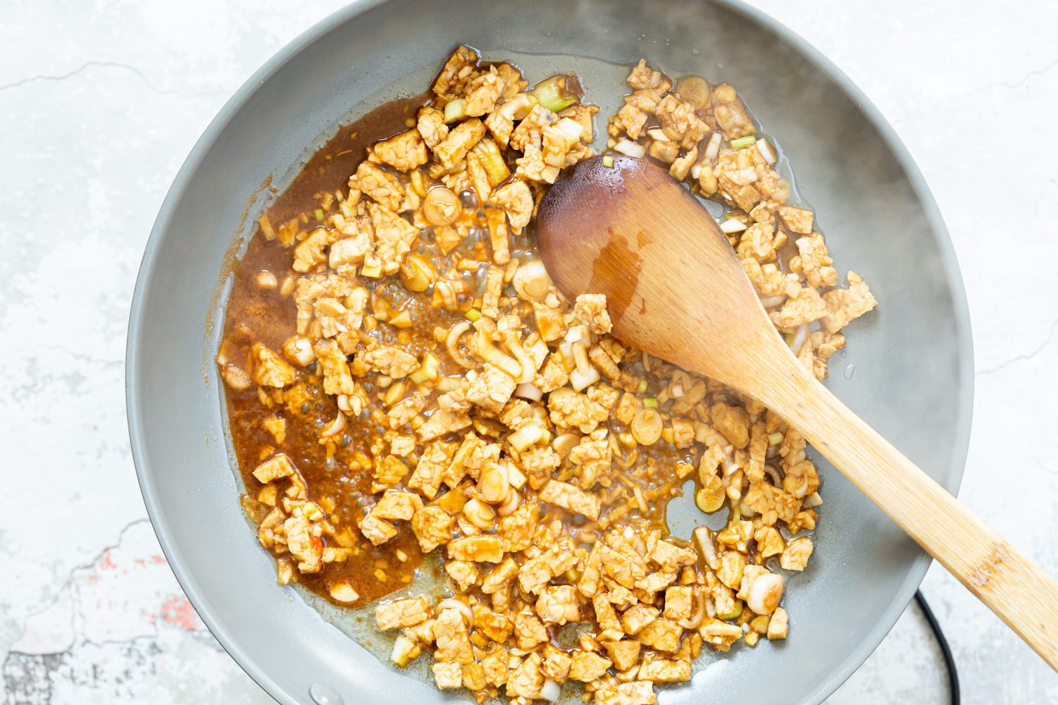 Our Lemongrass tempeh crumbles in grey skillet
