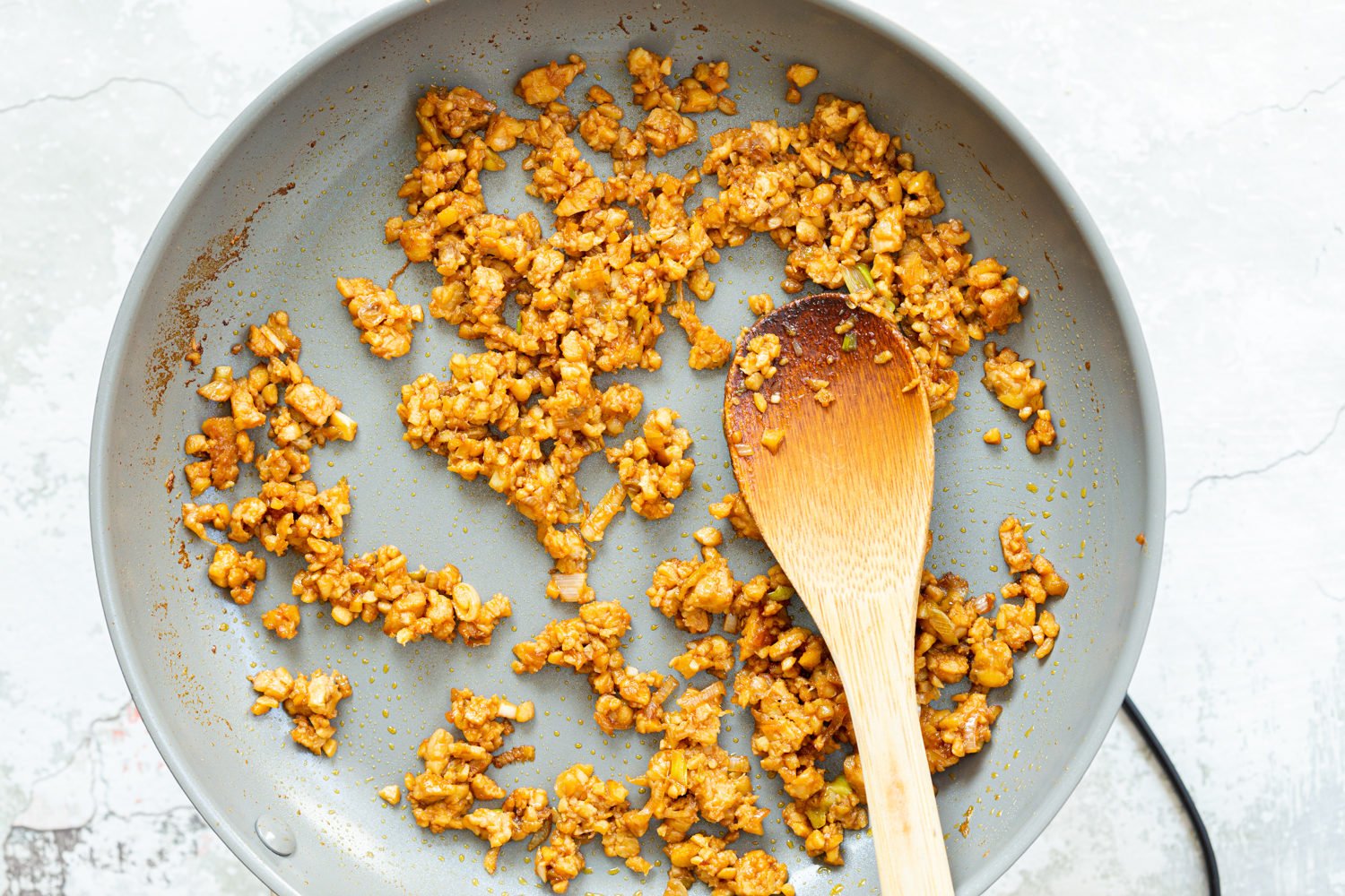 Our Lemongrass tempeh crumbles in grey skillet
