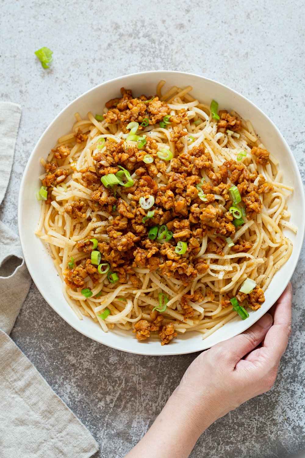 Sesame Noodles with Lemongrass Tempeh Crumbles in a white bowl