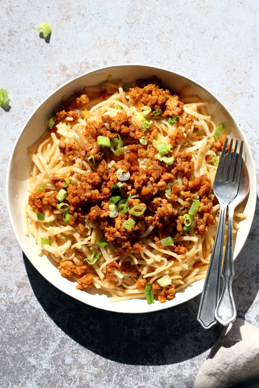Sesame Noodles with Lemongrass Tempeh Crumbles in a white bowl