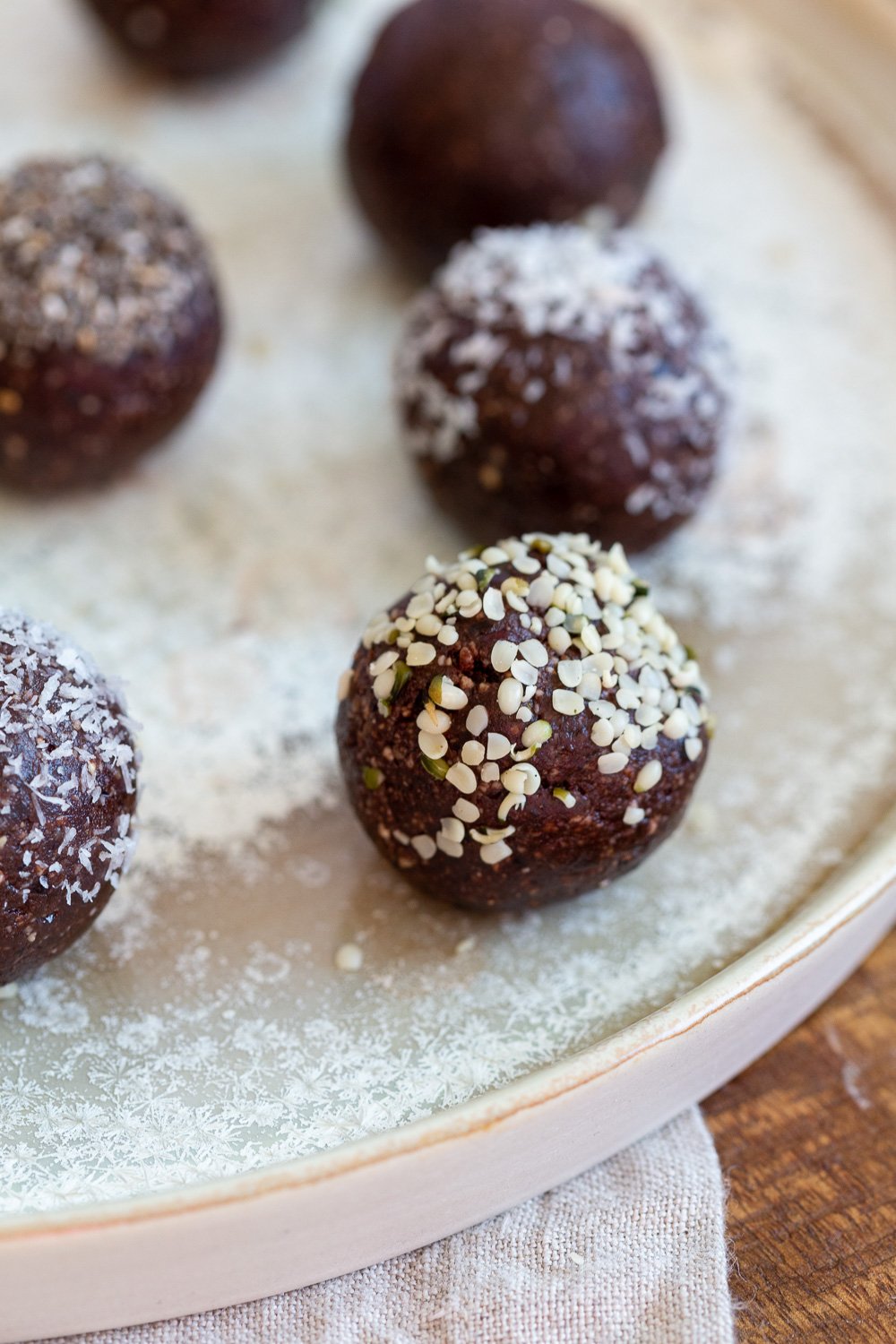 Our Raw Vegan Brownie Bites on white speckled plate