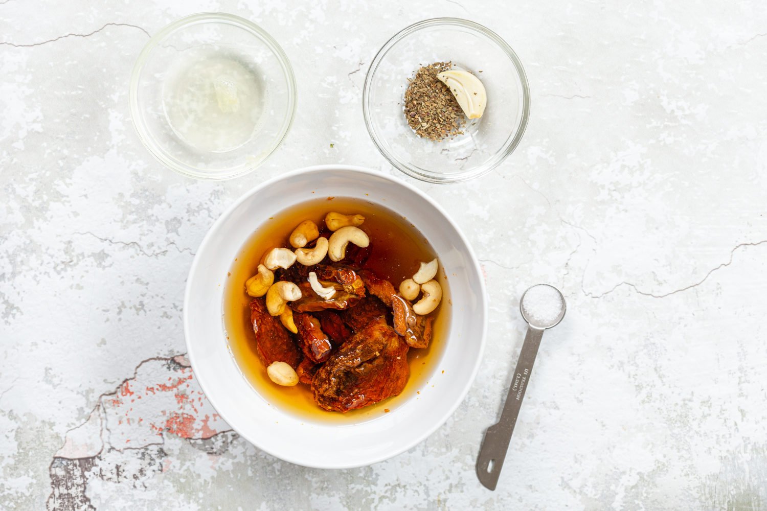 Ingredients for sundried tomato dressing in bowls