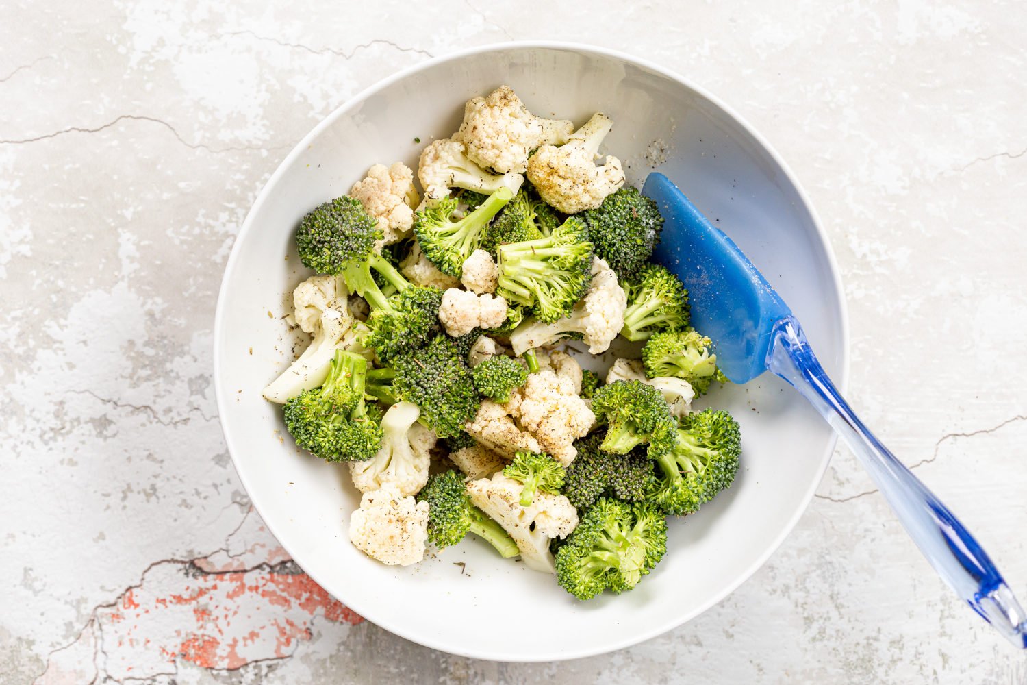Veggies for our Roasted Broccoli Cauliflower Salad in a whit bowl