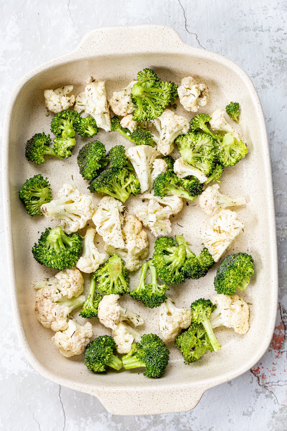 Veggies for our Roasted Broccoli Cauliflower Salad in a cream baking dish