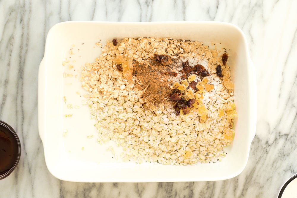 Dry ingredients for Vegan Gingerbread Baked Oatmeal in a white baking dish