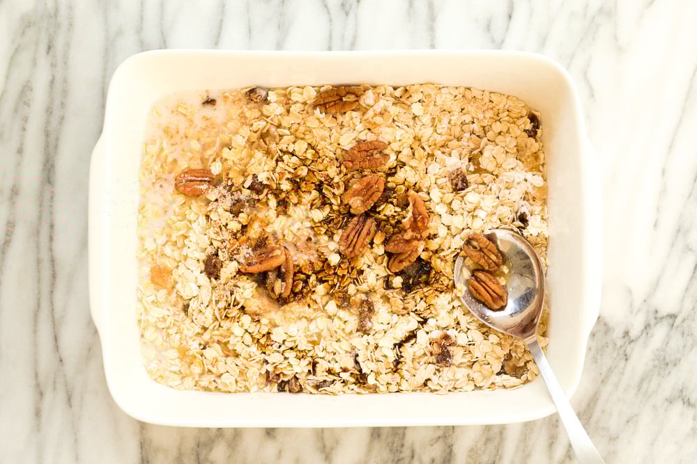 Dry ingredients for Vegan Gingerbread Baked Oatmeal in a white baking dish