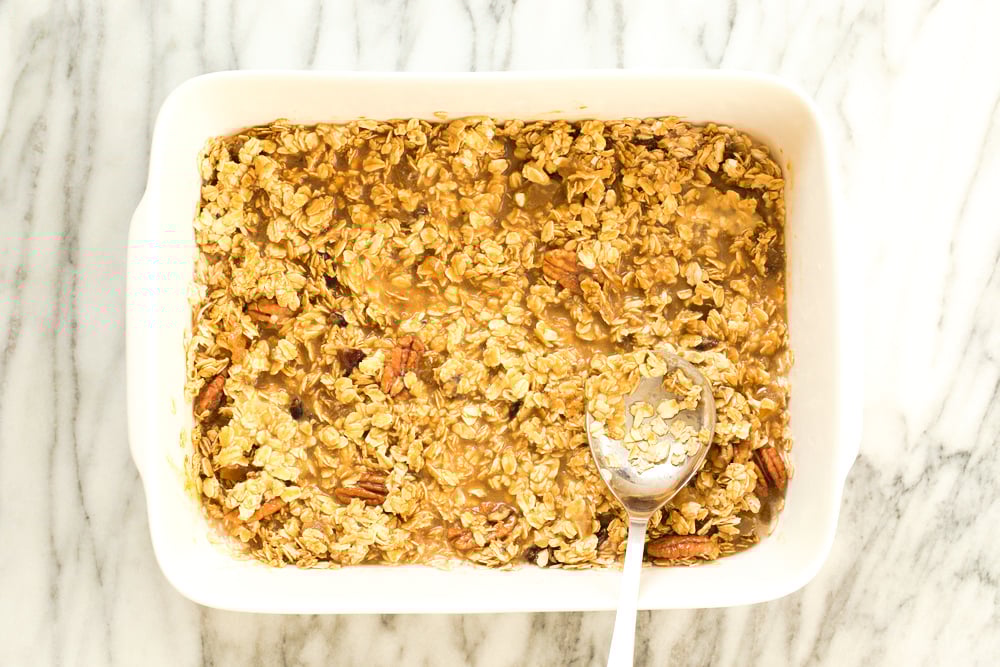Mixture for Vegan Gingerbread Baked Oatmeal in a white baking dish