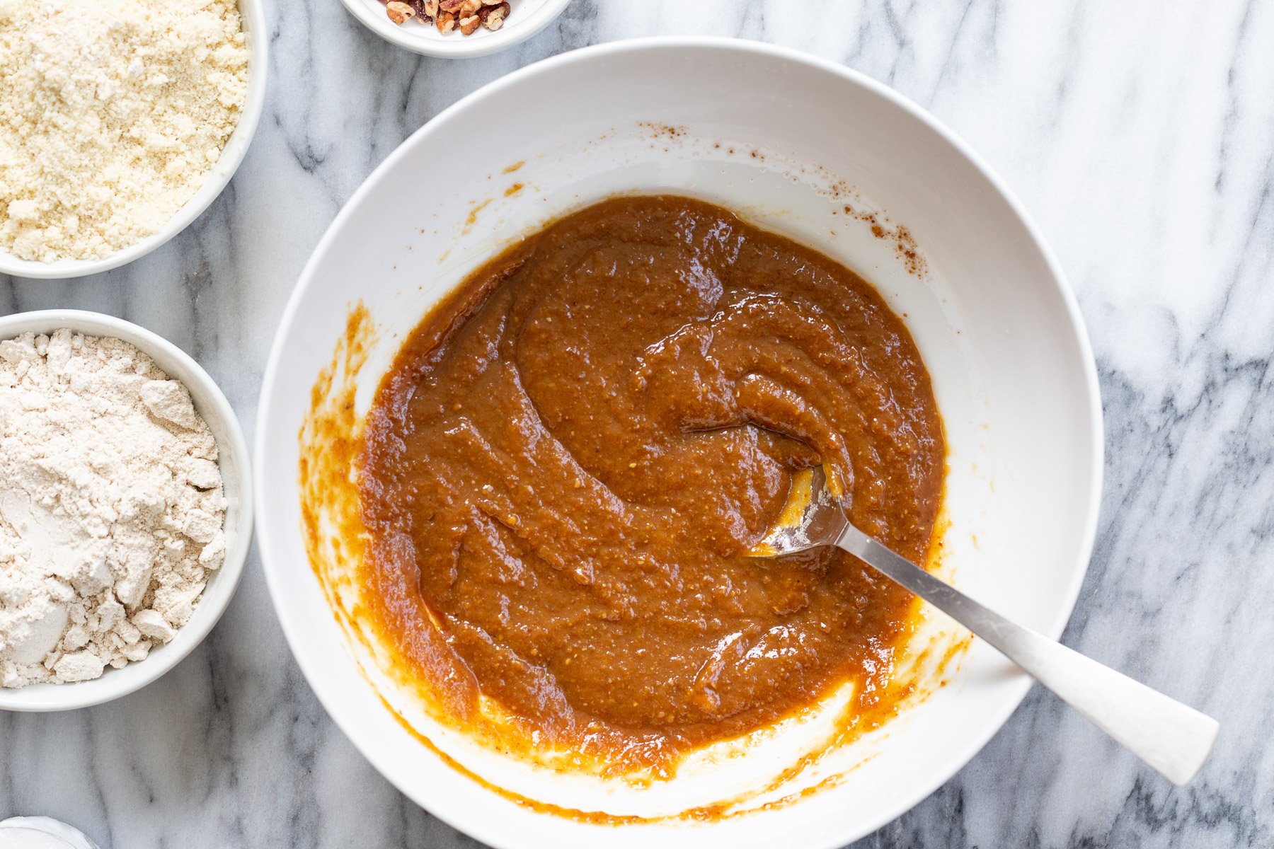ingredients for gluten free pumpkin muffins in white bowl
