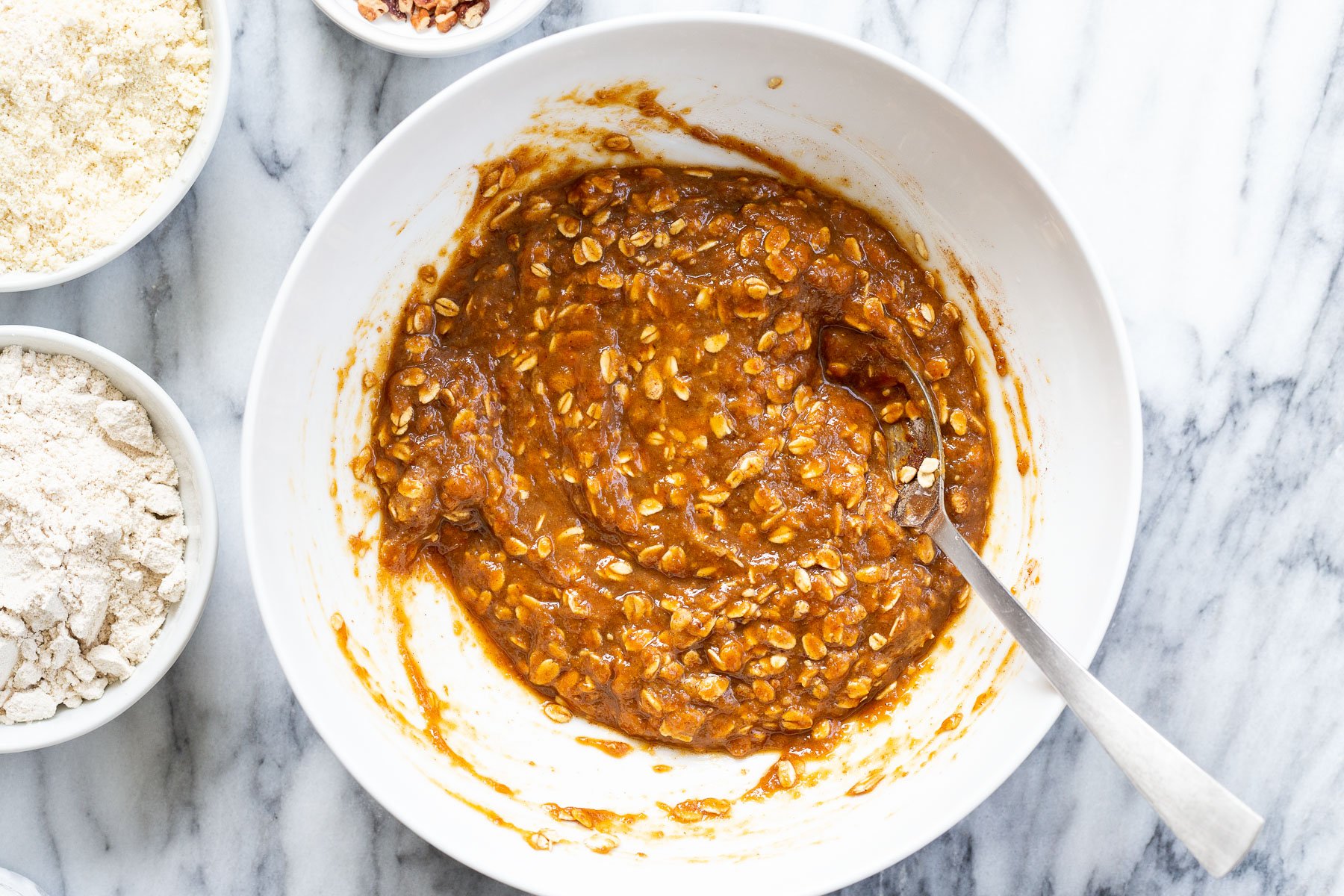 mixed ingredients for pumpkin muffins in white bowl