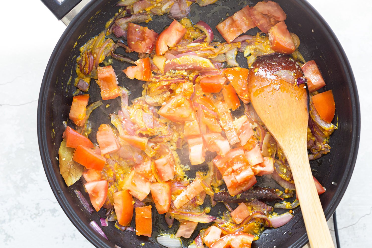 Ingredients for Kohlapuri sauce in black skillet