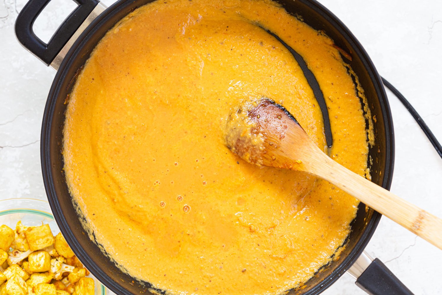 Kohlapuri Sauce in a Black skillet