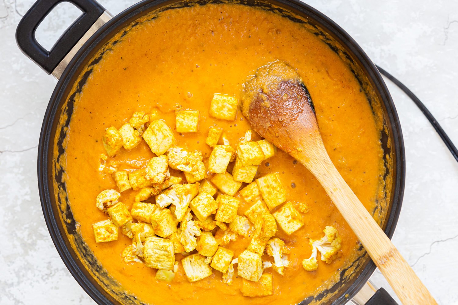 Tofu and Cauliflower in kolhapuri Sauce in a Black skillet