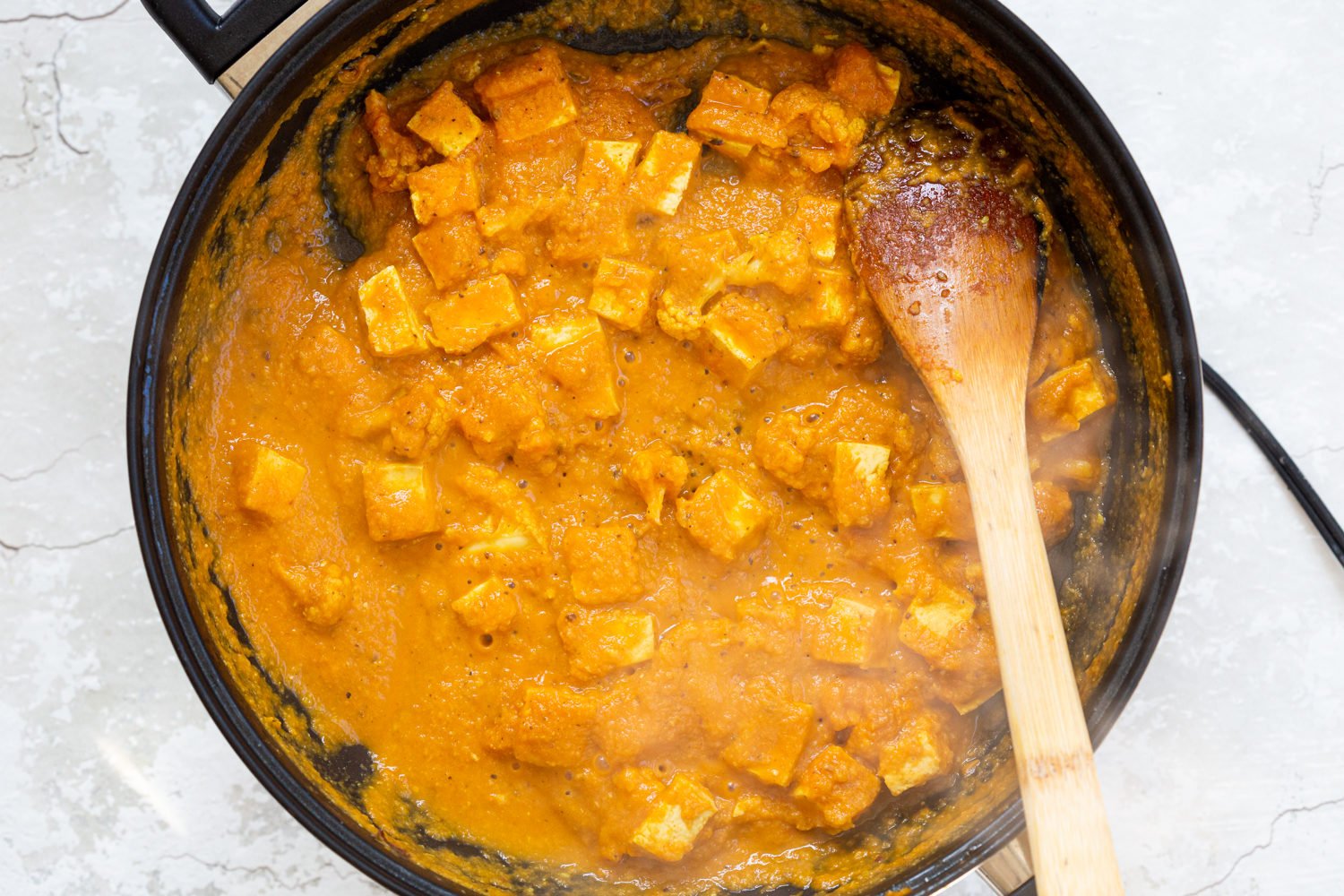 Tofu and Cauliflower in kolhapuri Sauce in a Black skillet