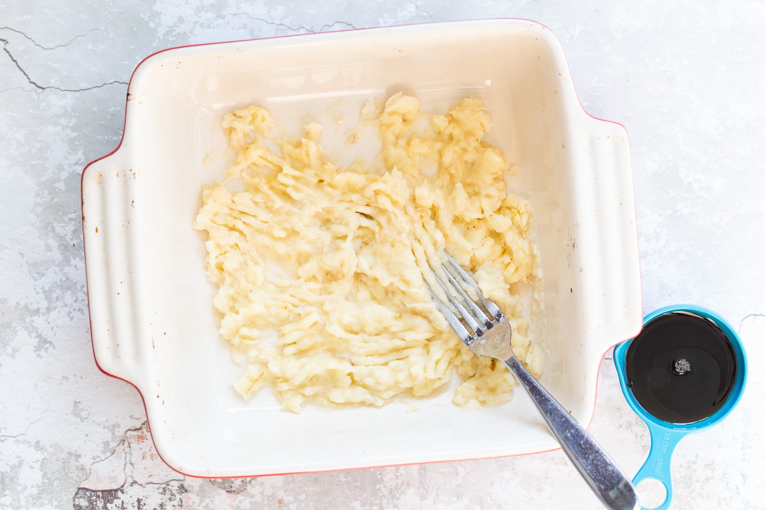 Mashed Bananas for Our Vegan Banana Bread Baked Oatmeal in a white baking dish