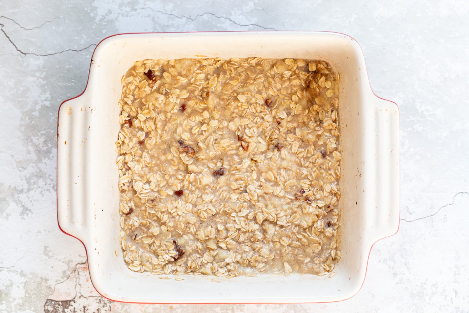 Our Vegan Banana Bread Baked Oatmeal in a white baking dish before baking