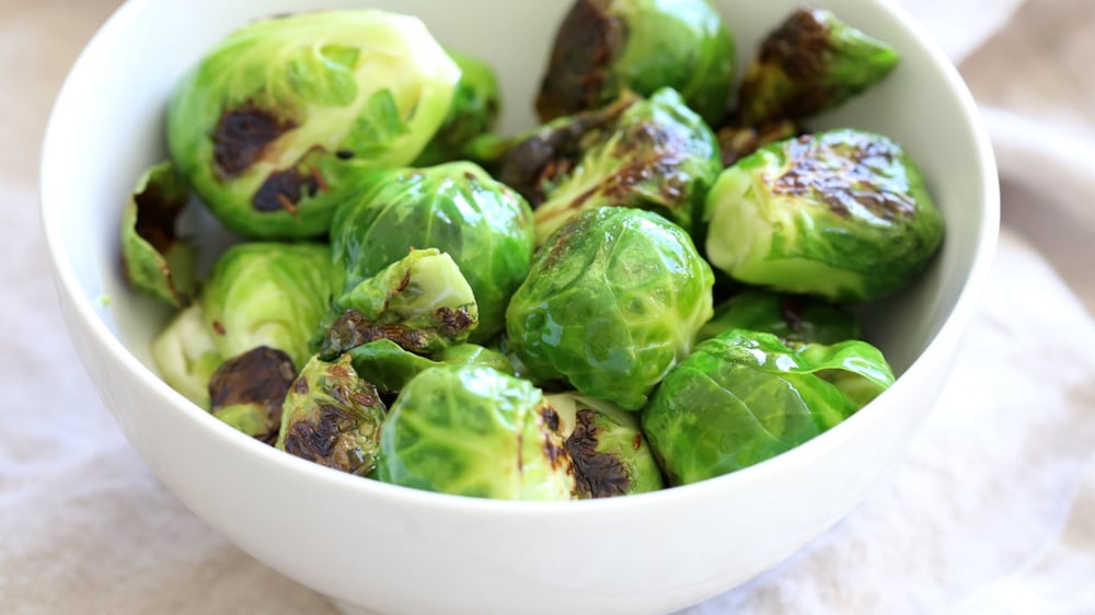 Our Curried Caramelized Brussels Sprouts in white bowl