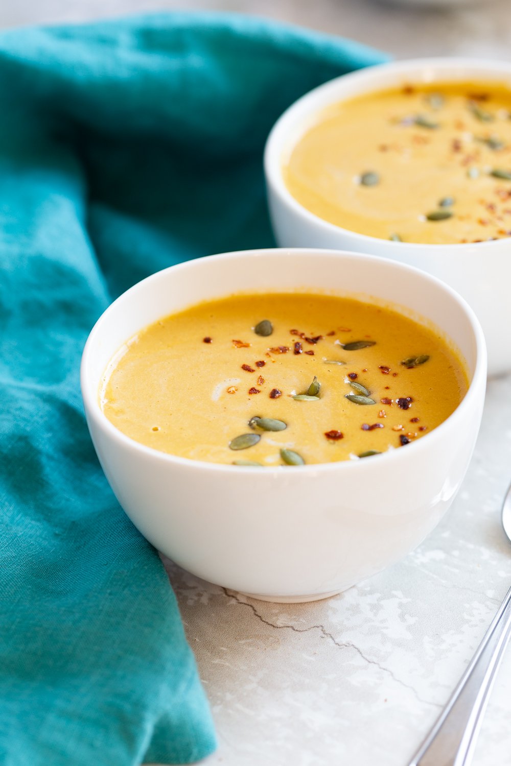Our Creamy Vegan Pumpkin soup in white bowls