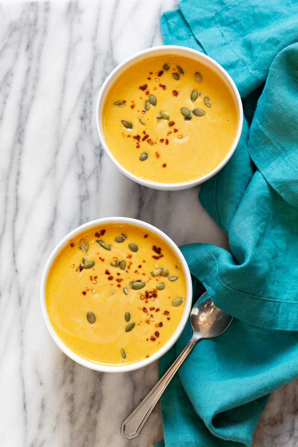 Our Creamy Vegan Pumpkin soup in white bowls