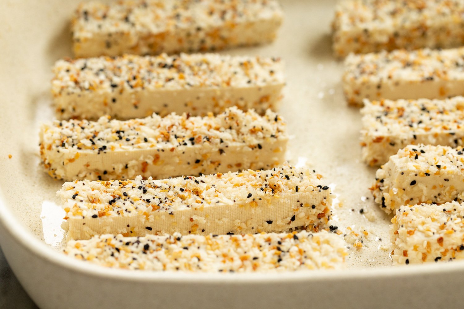 Our Breaded Everything Bagel Tofu in parchment lined baking dish