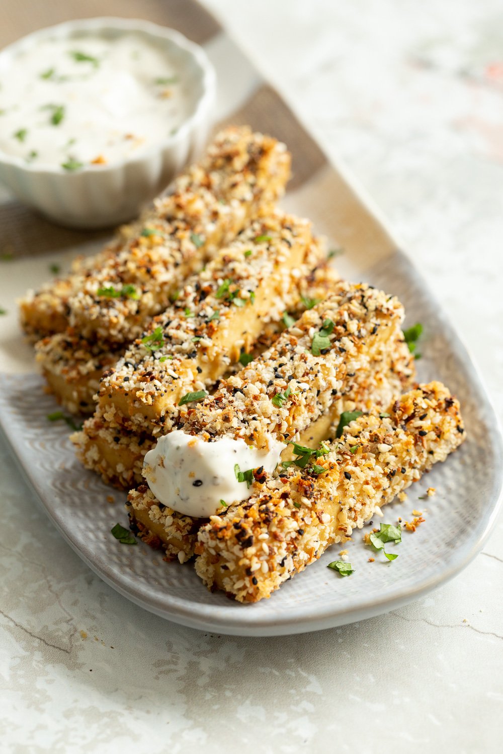 Our Everything Bagel Tofu on a white and grey serving platter