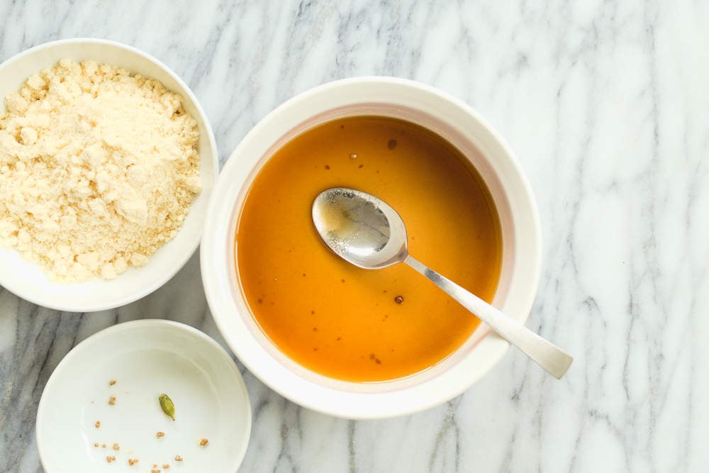 Sugar mixture for our Vegan Almond Halwa in a white baking dish