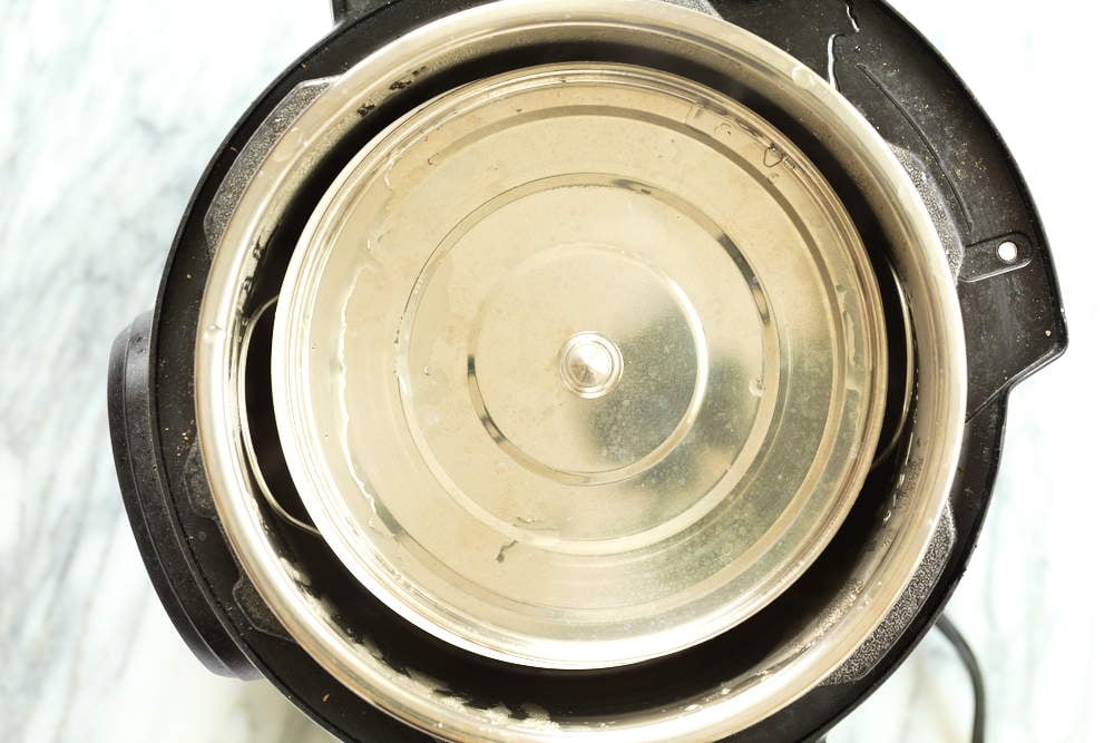 Baking dish for our almond halwa covered with a stee lplate