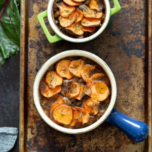 Our Vegan Mushroom Pot Pie in green and blue baking dishes on a baking sheet