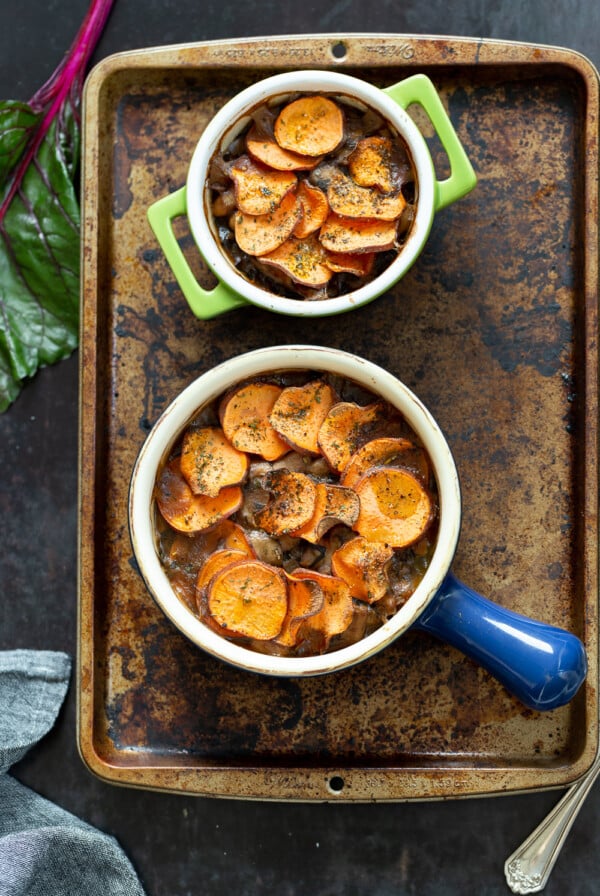 Our Vegan Mushroom Pot Pie in green and blue baking dishes on a baking sheet
