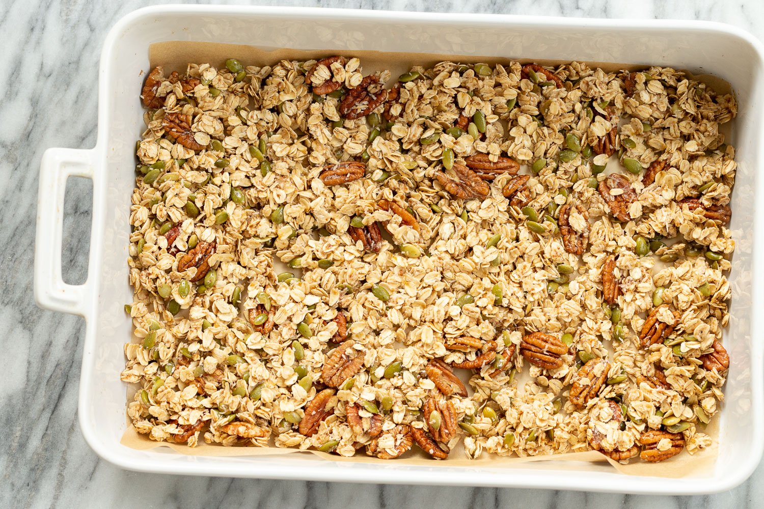 Our Vegan Maple Pecan Granola in a white baking dish