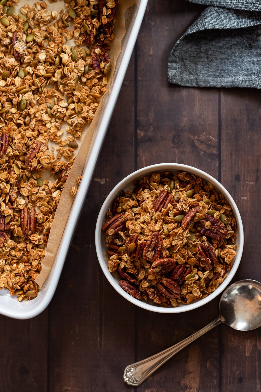 Our Maple Pecan Granola in white bowl and baking dish