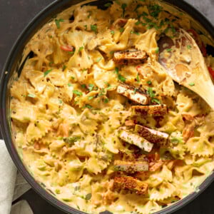 Vegan Creamy Cajun Pasta with Crisp Breaded tofu in a black skillet
