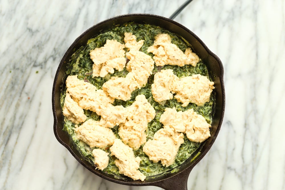 Biscuit topped Creamed spinach in cast iron skillet