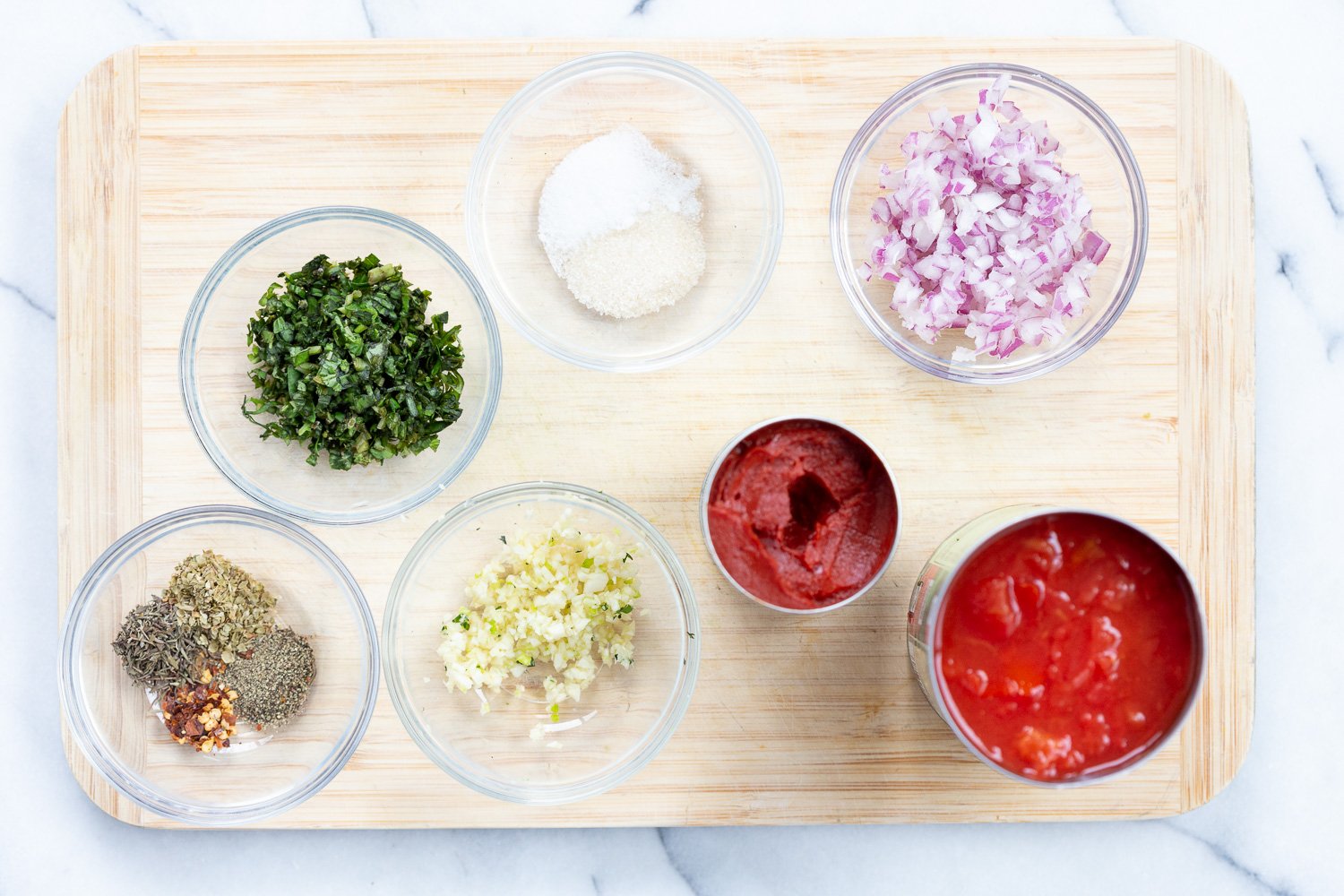 Ingredients for chunky marinara sauce in bowls