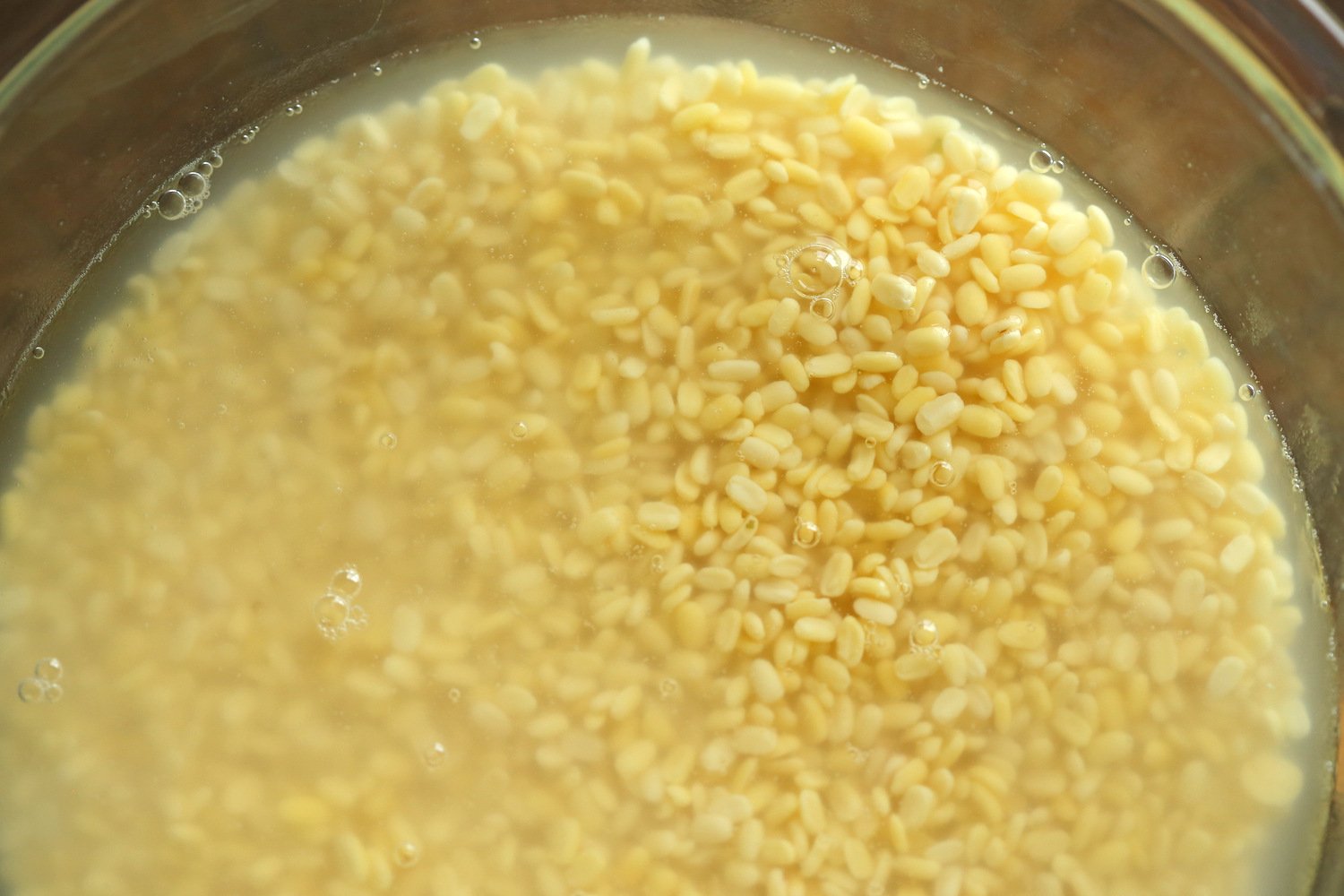 Soaked Moong Dal in a glass bowl