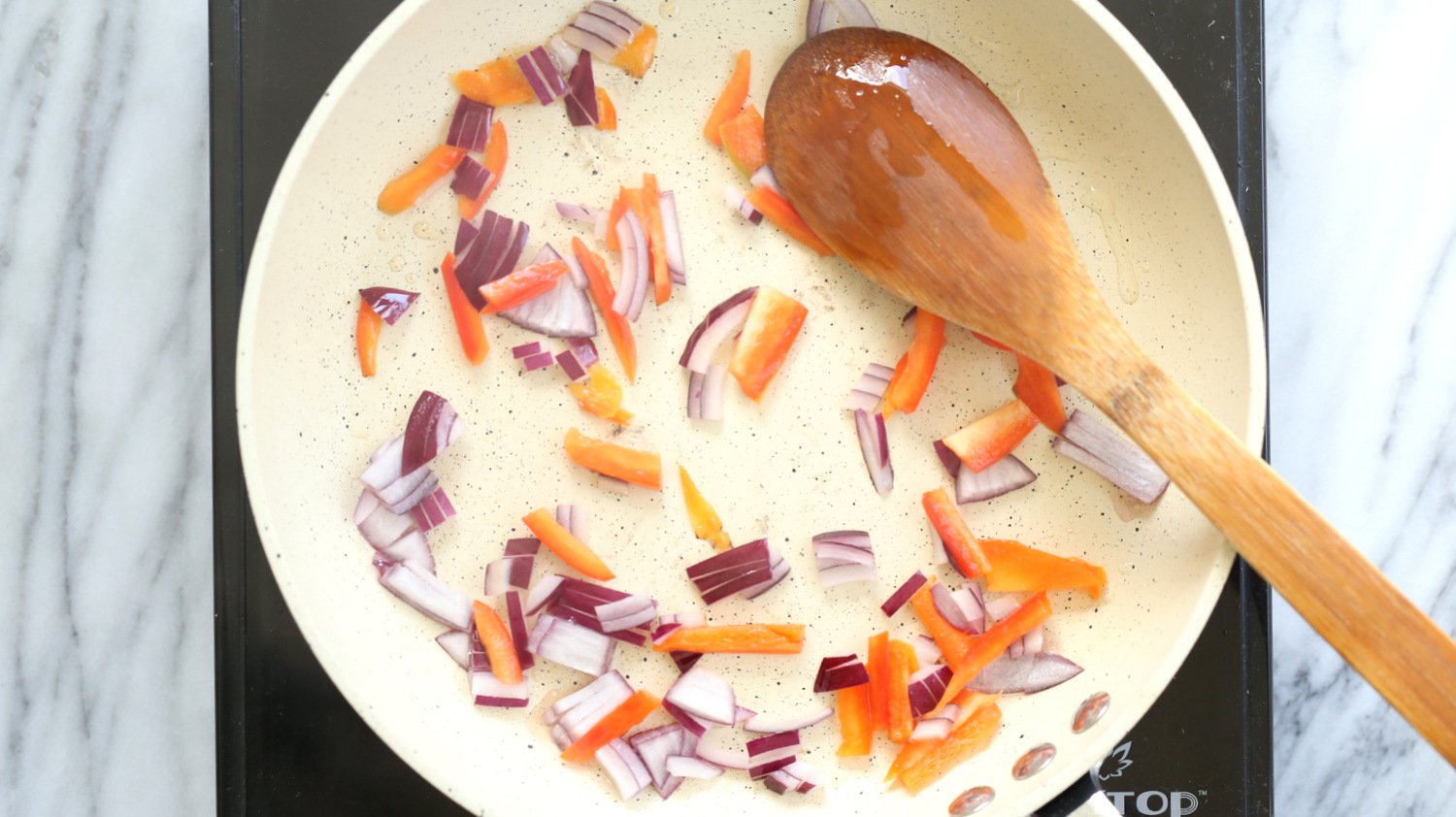 Veggies for Vegan Omelet on a white skillet