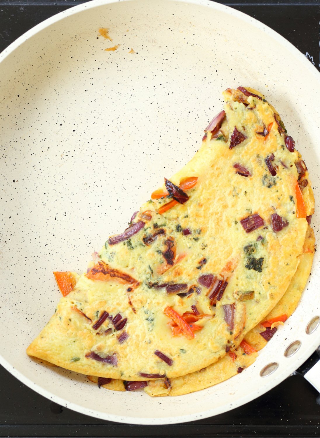 Veggie Vegan Omelet on a white skillet