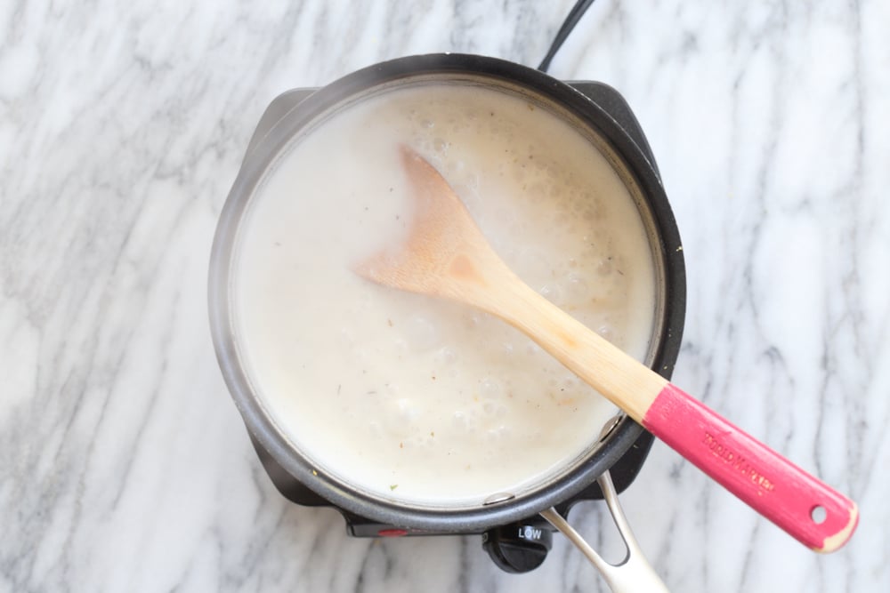 Scalloped potato creamy sauce mixture in a saucepan