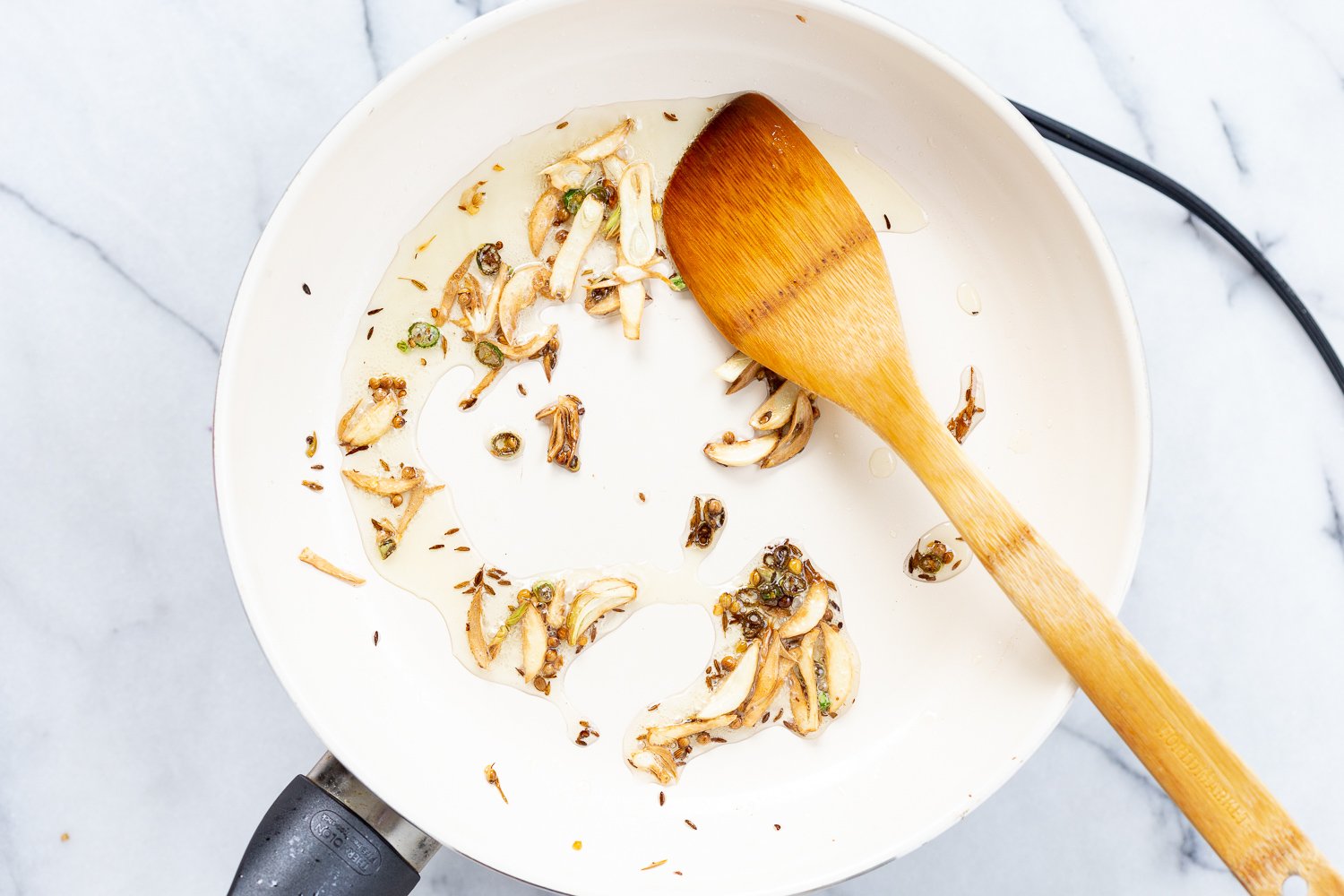 Garlic in white skillet