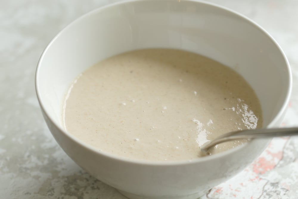 Batter for Banana Oat Pancakes in a whit bowl