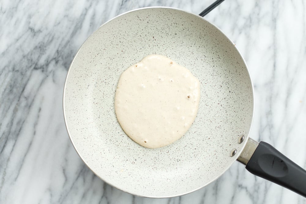 Banana Oat Pancake batter on white stone skillet