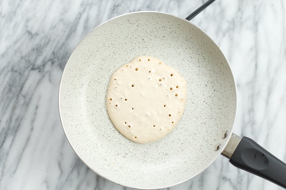 Banana Oat Pancake batter on white stone skillet