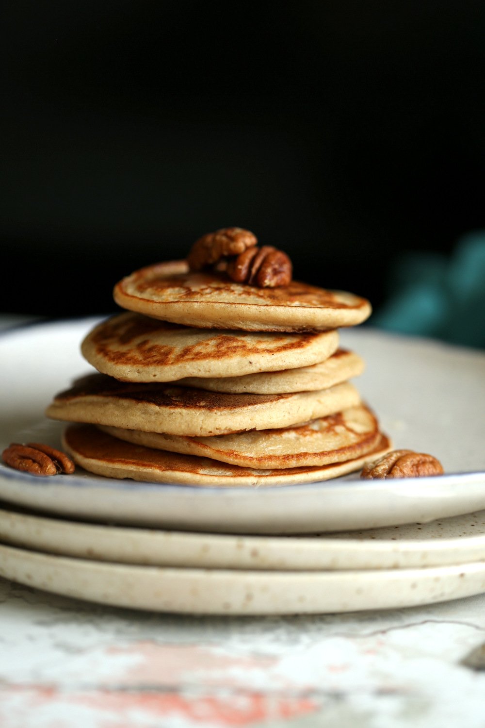 Vegan Banana Oat Pancakes Stacked on white plates